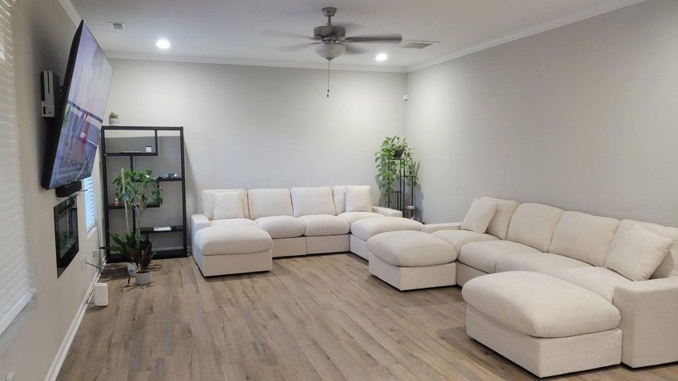 Completed white sectional furniture assembly in a finished living room by Blanchard Home Services
