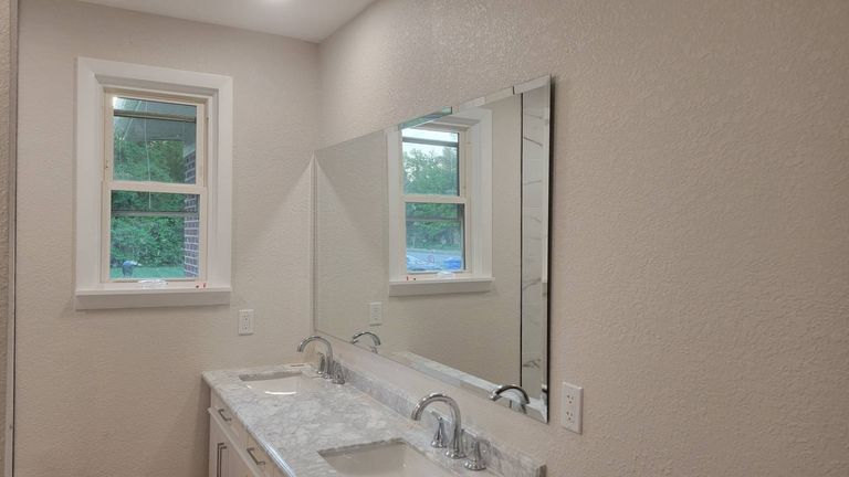 Large bathroom mirror installed above a double vanity in Deep Creek, Chesapeake by Blanchard Home Services