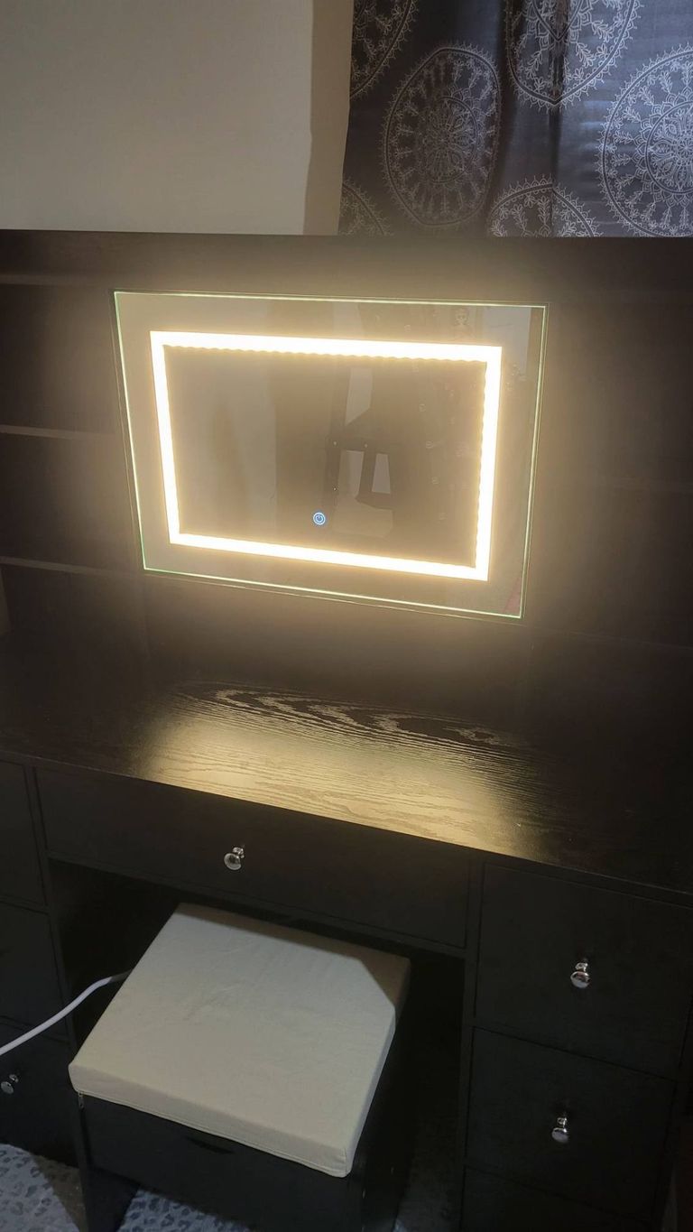 Black vanity with illuminated mirror assembled in Portsmouth by Blanchard Home Services